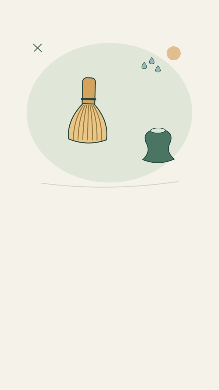 Bamboo whisk drying on a stand beside water droplets